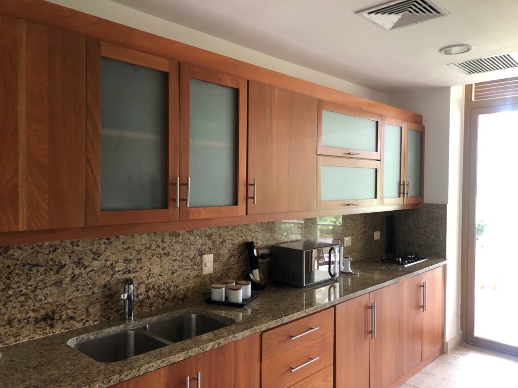 Full kitchen with wood cabinetry and granite counters at the 3BR Los Altos Penthouse
