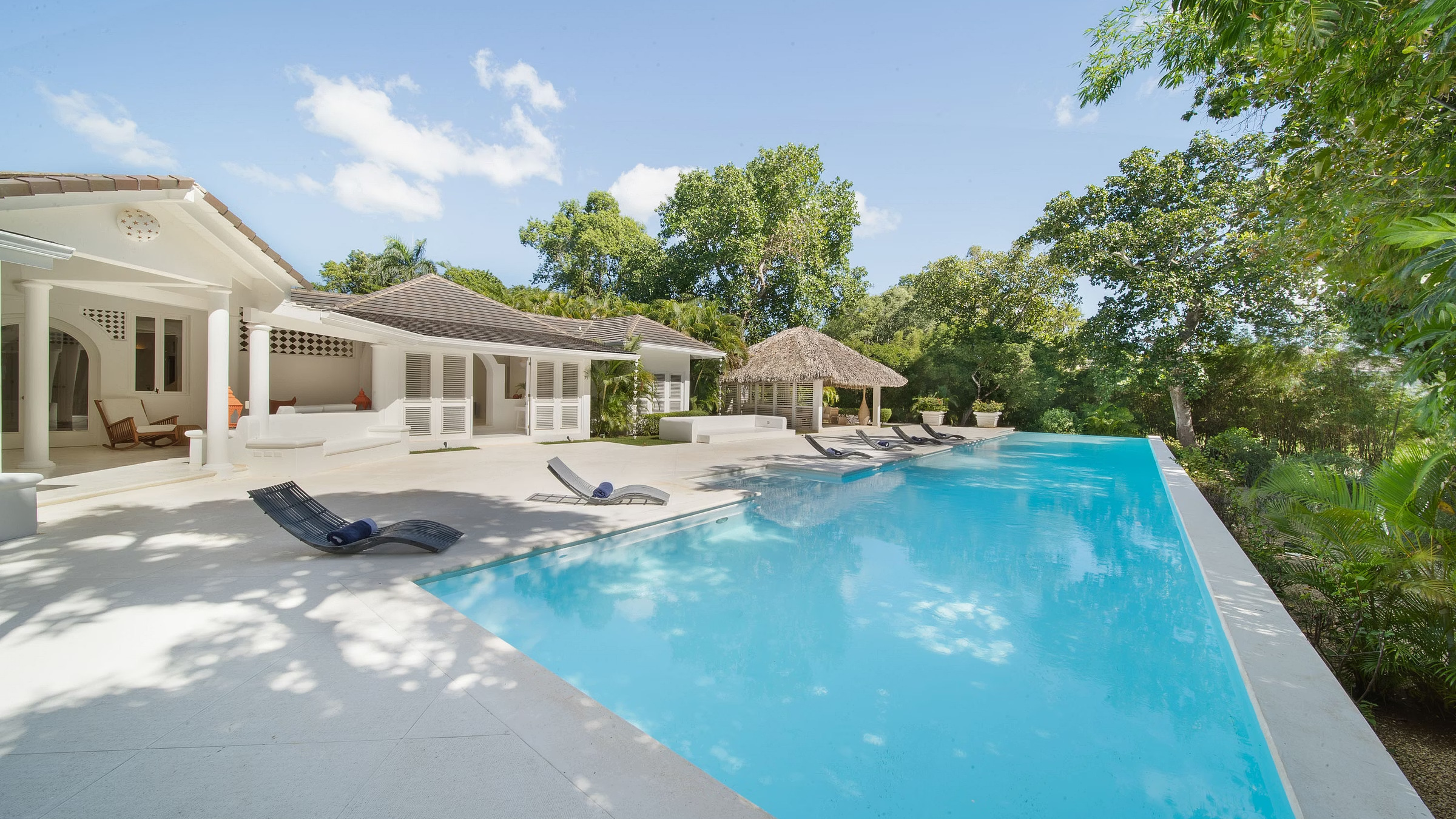 Long pool beside the white Cacique Ocean-View Villa