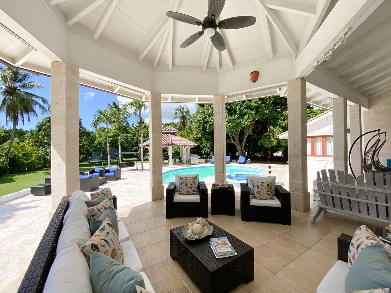 Open living room in coral stone opening to the pool at Cajuiles Private Pool Estate