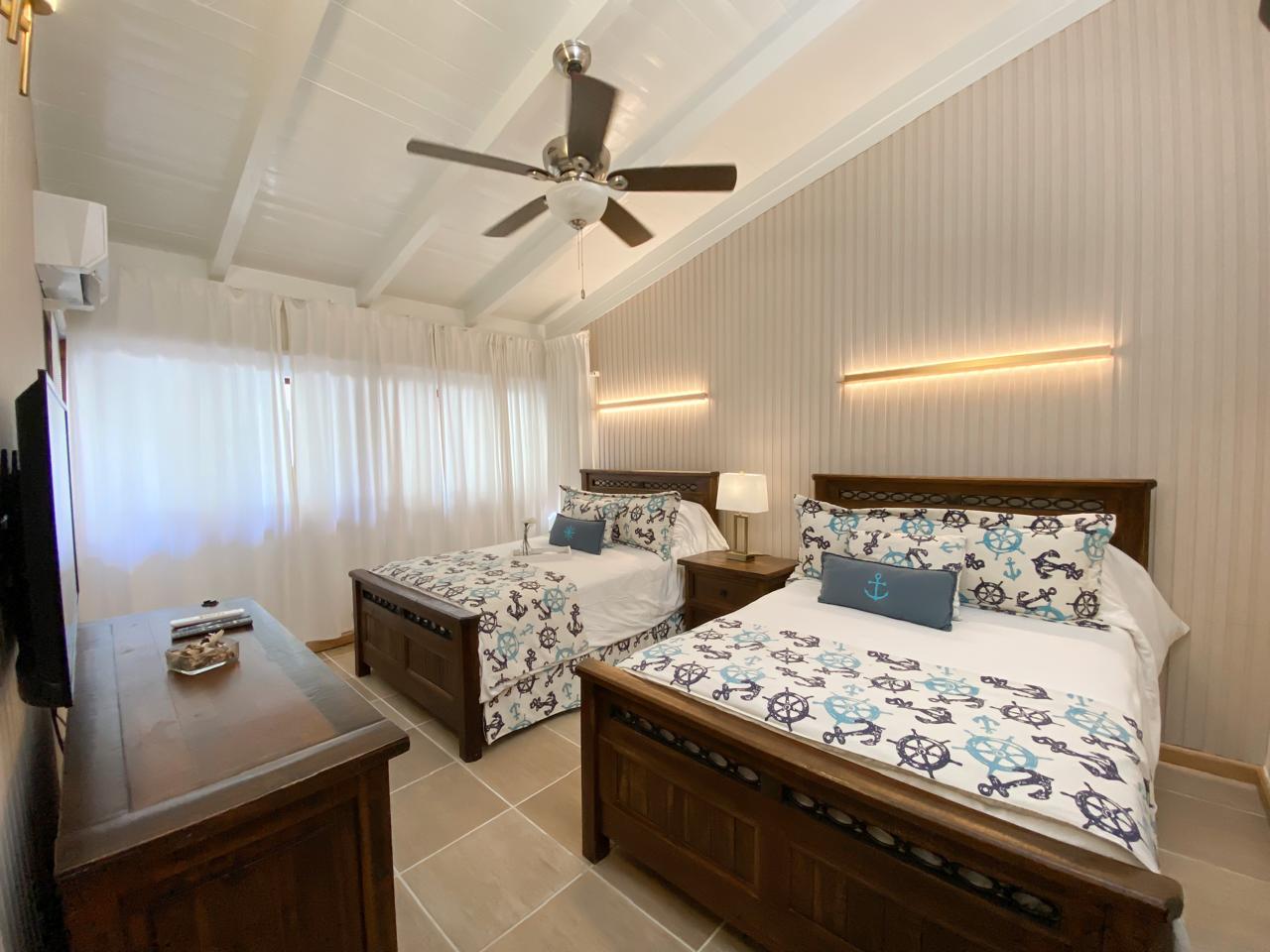 Bedroom suite with twin beds and garden view at Cajuiles Private Pool Estate