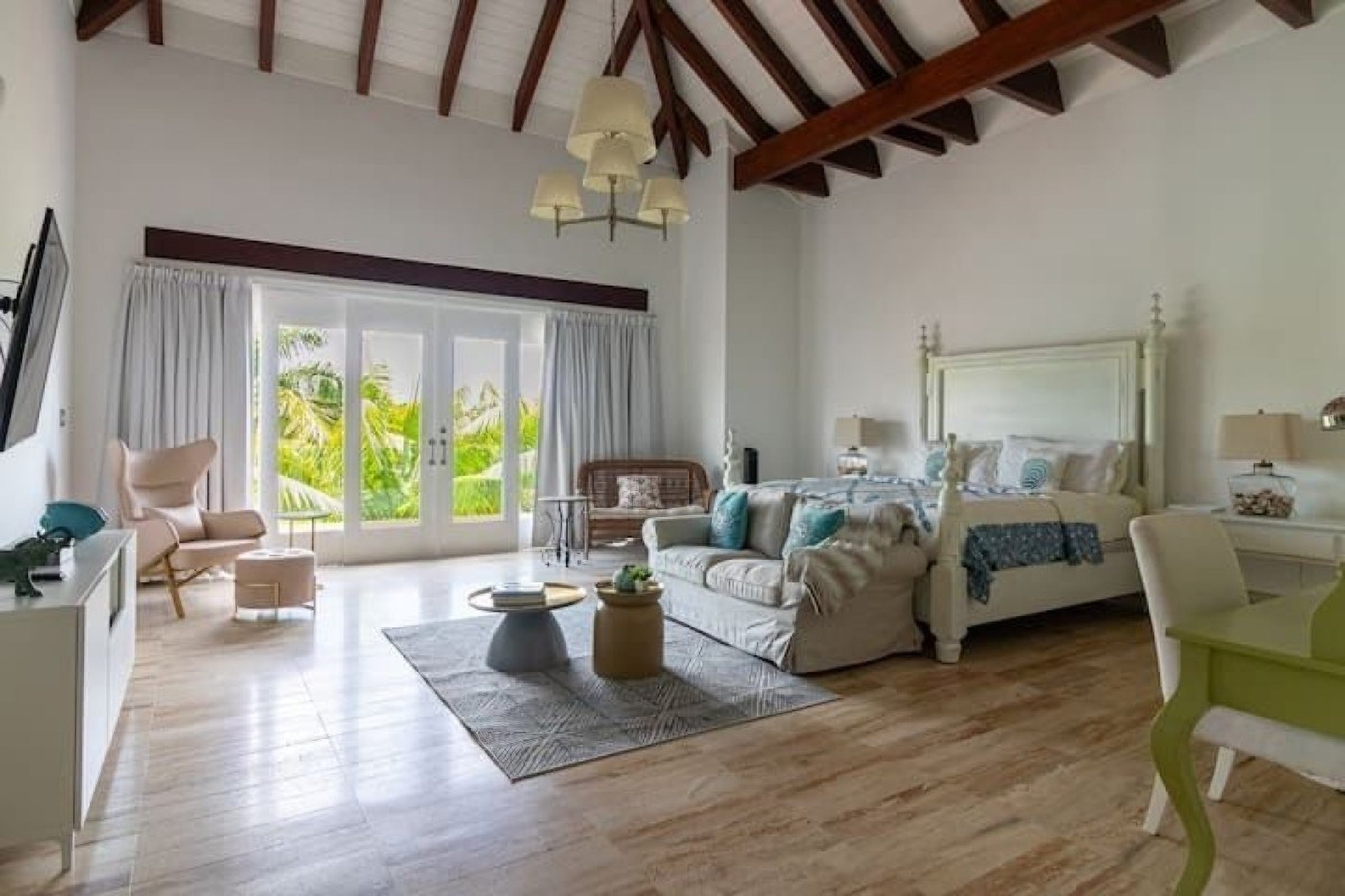 Master suite with a four-poster king bed at the 7BR Las Lomas Villa