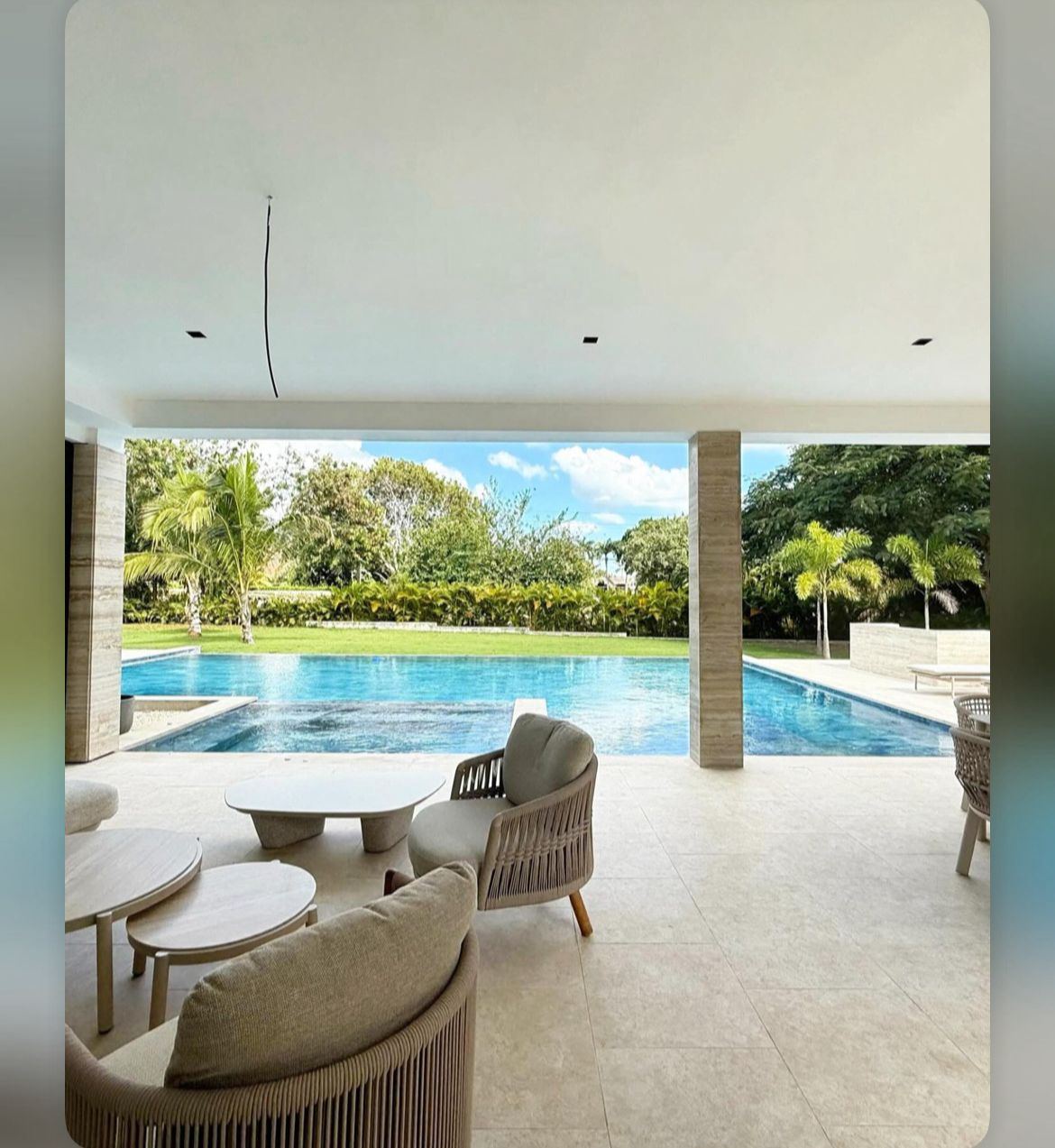 Covered outdoor lounge facing the private pool at 5BR Los Lagos Contemporary Estate