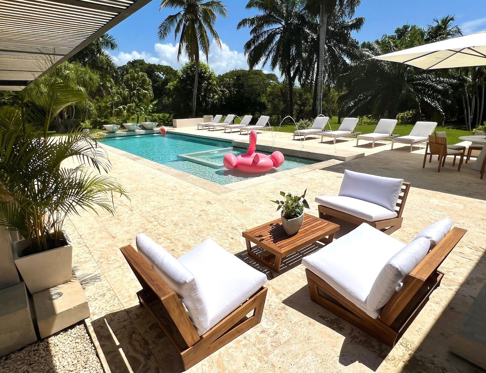 Pool, sun deck and palms at the Los Mangos Seven-Bedroom Villa, Casa de Campo