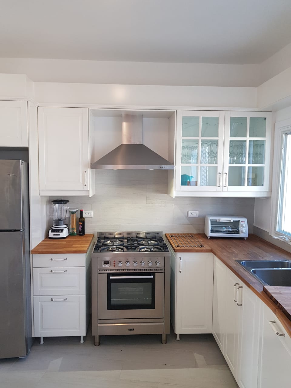 Modern kitchen with stainless gas range at Marina Apartment with Roof Terrace