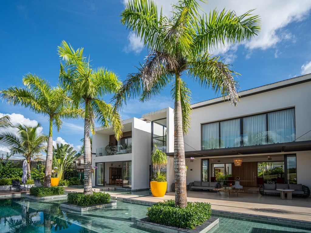 Royal palms rising through the private pool