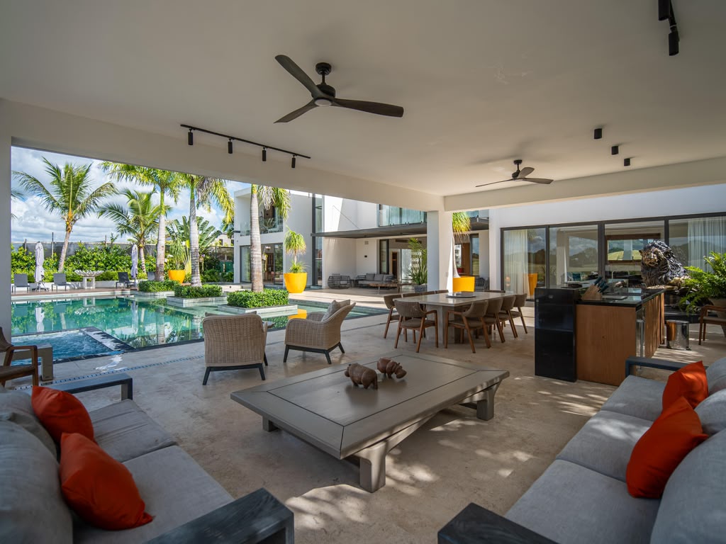 Open-plan living room flowing straight onto the pool terrace